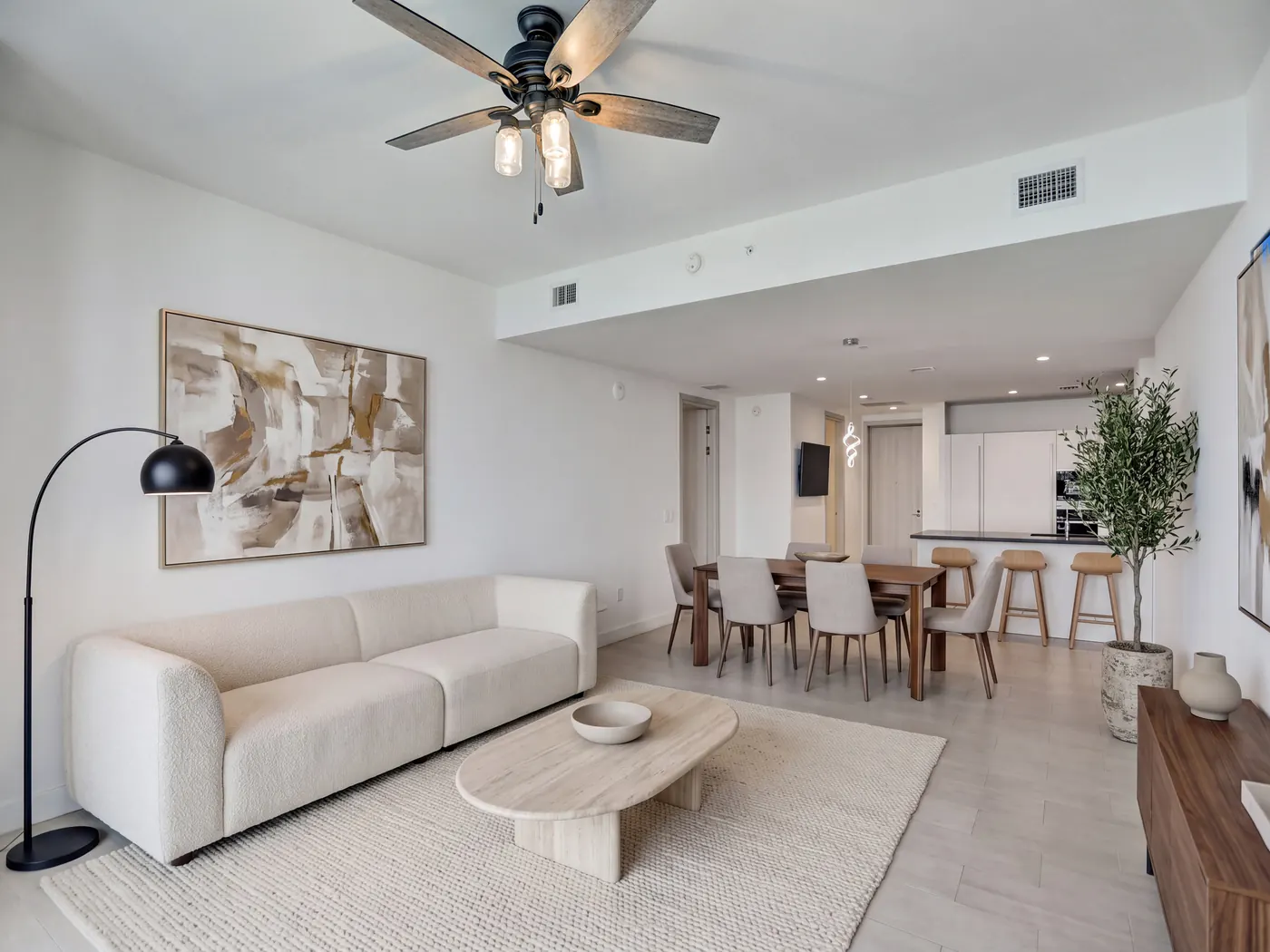 Bright penthouse living area with dining table and open kitchen